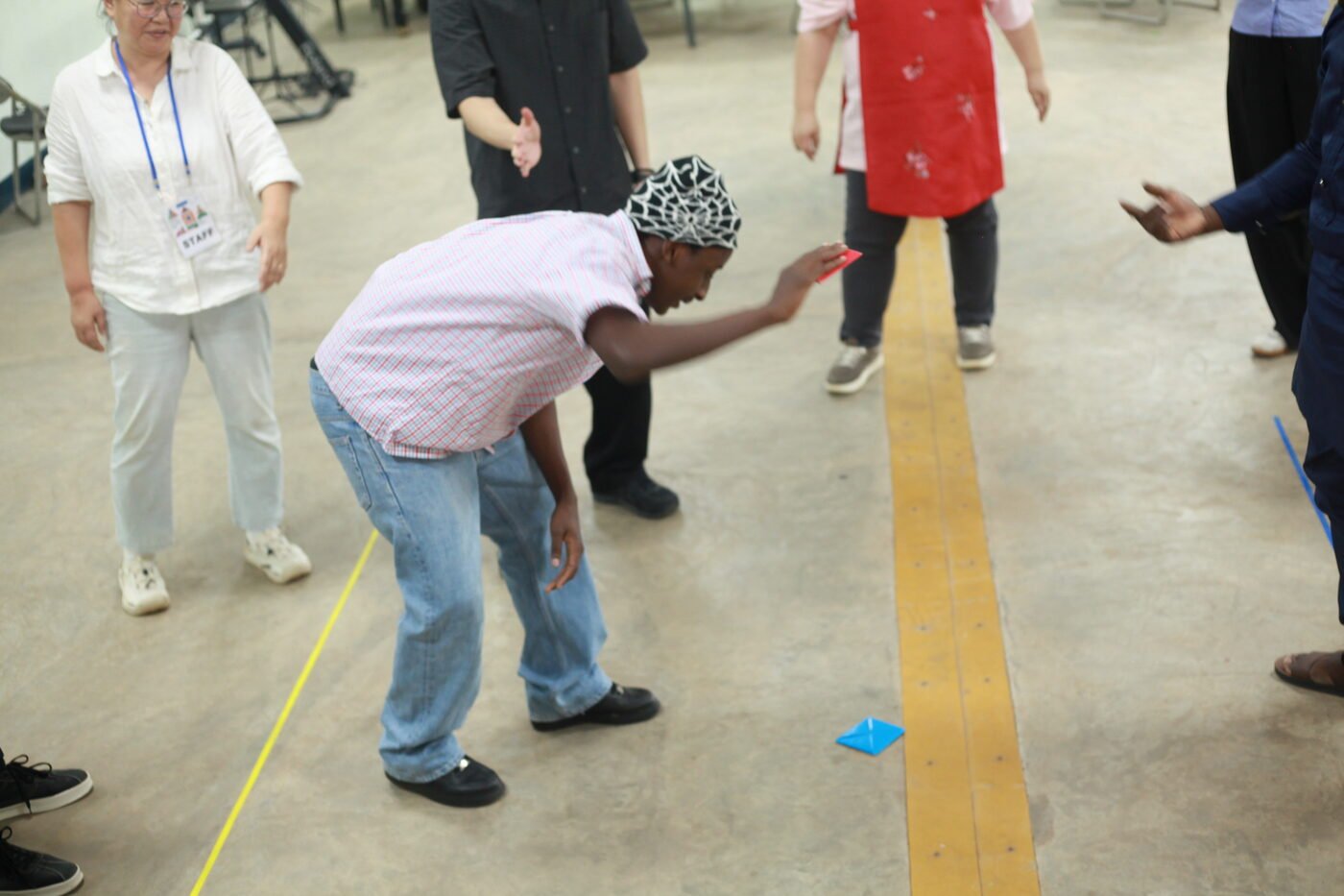 Participant playing a traditional Korean game guided by Sejong staff