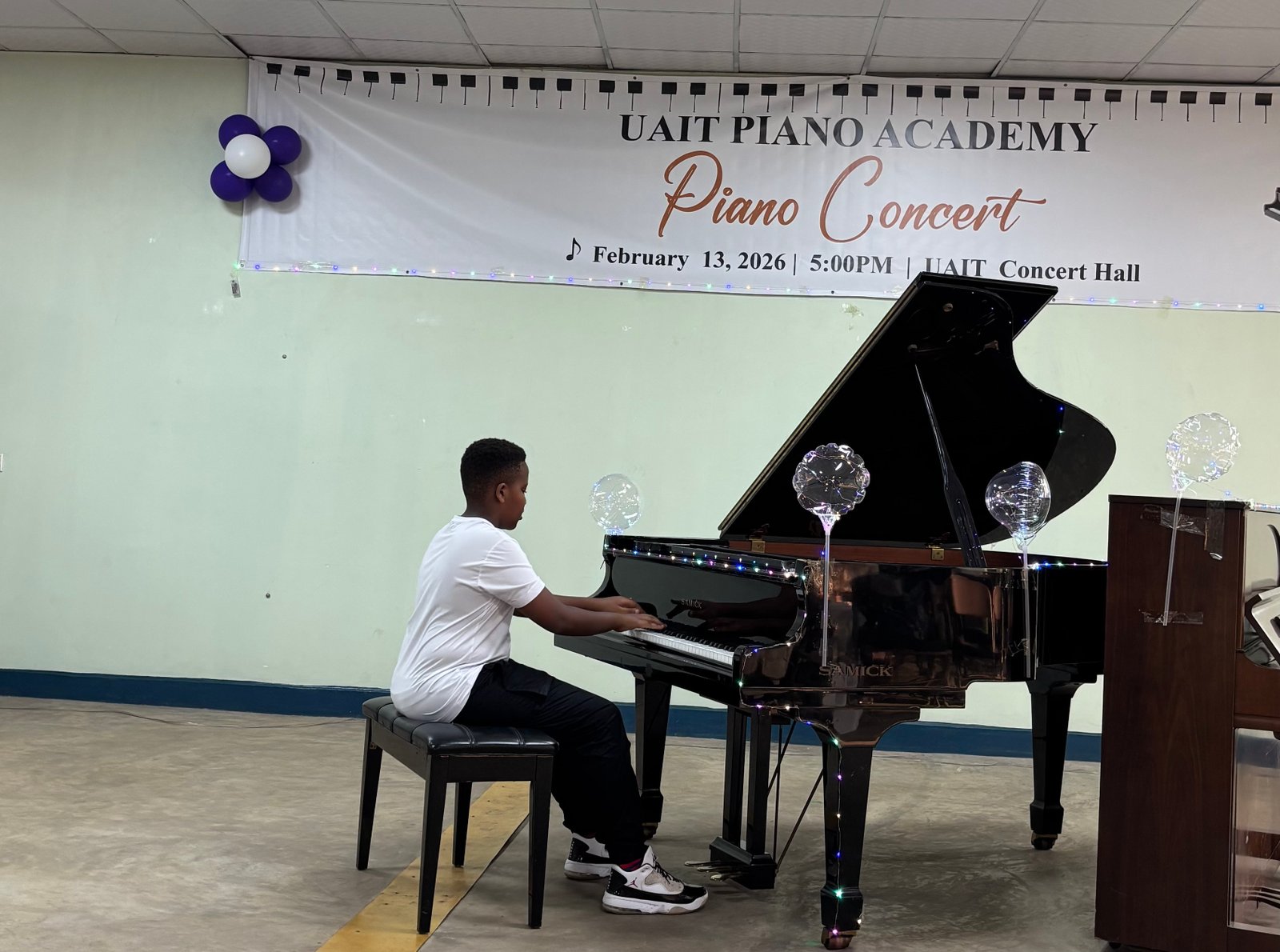 Young boy performing confidently on stage