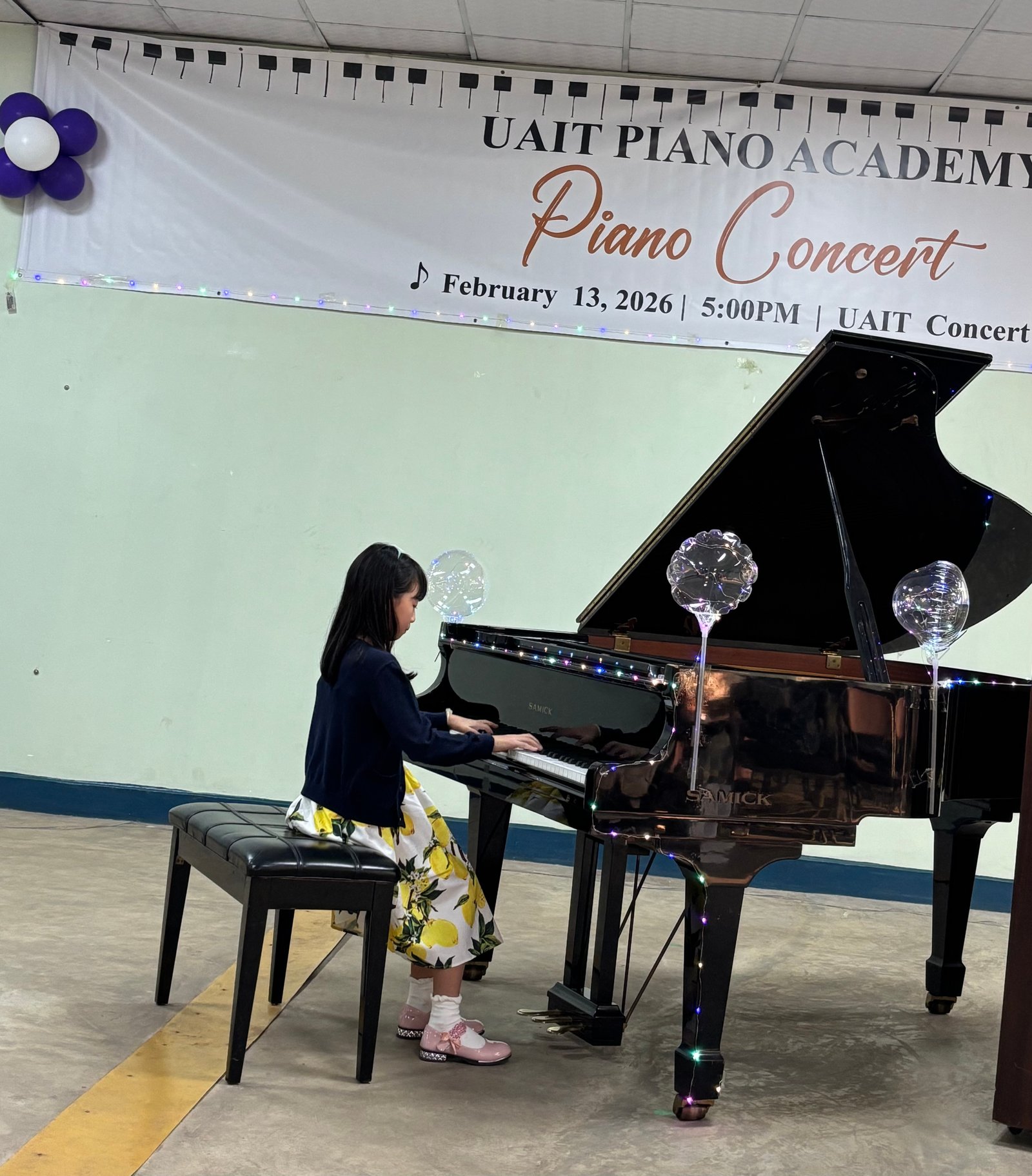 Girl in floral dress performing on the piano
