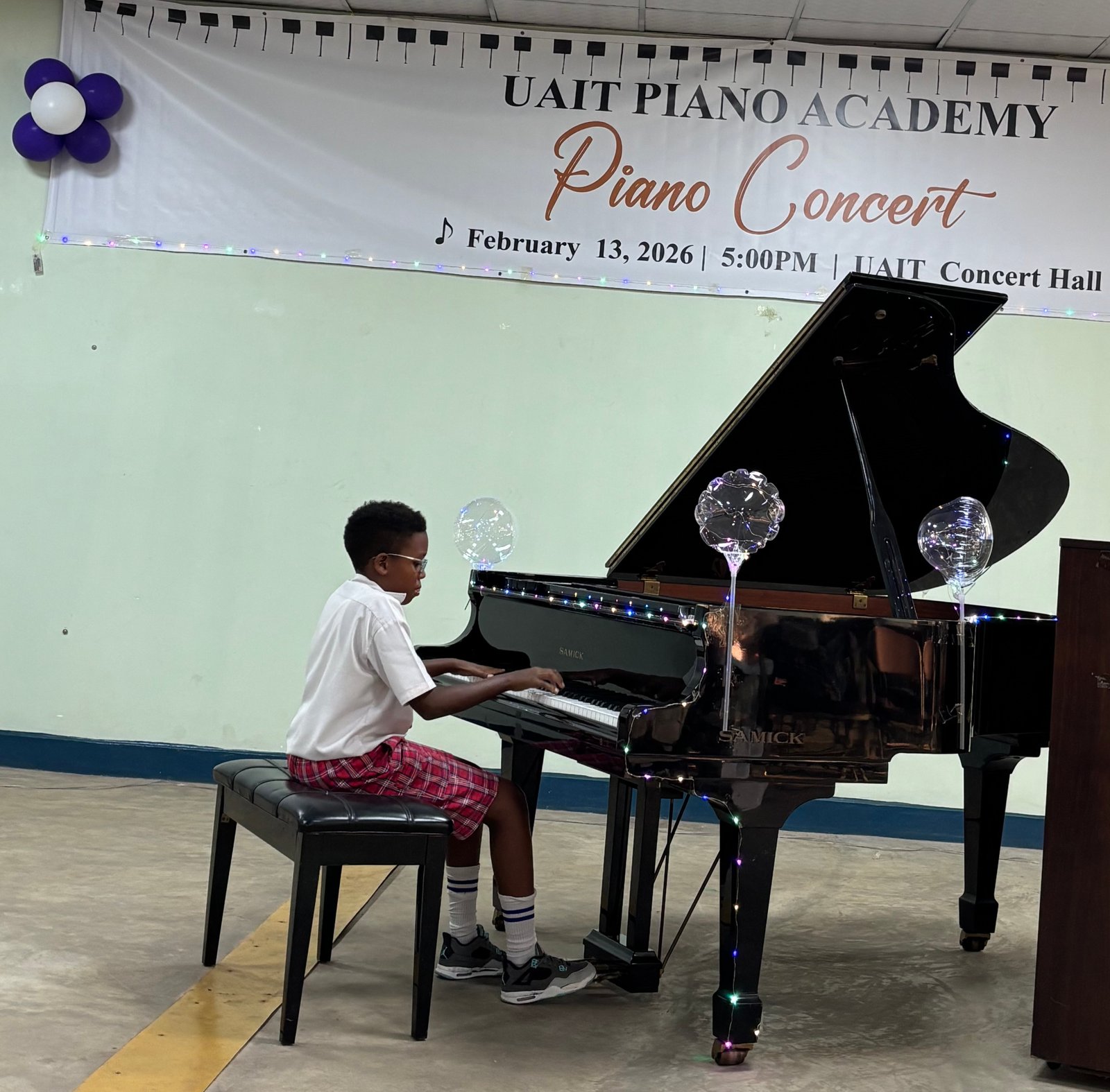 Young boy performing solo on the grand piano